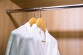 White bathrobes hanging in wardrobe Royalty Free Stock Photo