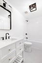A white bathroom with black fixtures. Royalty Free Stock Photo