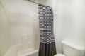 White bathroom interior with black and white stripes shower curtain Royalty Free Stock Photo