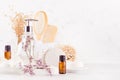 White bathroom interior with natural bamboo accessories and beauty products - essential oil in amber glass, towel, sponge, soap. Royalty Free Stock Photo