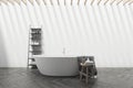 White bathroom interior with tub and shelf Royalty Free Stock Photo