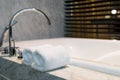 Bathroom towel on a white marble bathtub Royalty Free Stock Photo