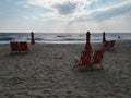 White beach chairs and a blue umbrella are set up on a sandy beach, ready to enjoy a sunny day Royalty Free Stock Photo