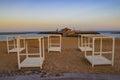 White beach chairs with red sand on the island of Fuerteventura- Caleta de Fuste