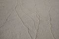 White beach sand whith wave patterns on it. Royalty Free Stock Photo