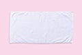 White beach towel mock up isolated with clipping path on pastel pink background, flat lay top view Royalty Free Stock Photo