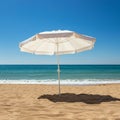 A white beach umbrella stands open on a sandy beach, casting a distinct shadow. Royalty Free Stock Photo