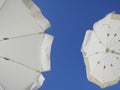 White beach umbrellas against the blue sky. Marfa, Mellieha, Malta Royalty Free Stock Photo