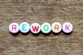 White bead with letter in word rework on wood background