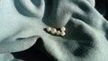 White beads lie on a velvet blue fabric. Jewelry on the curtains. A beautiful combination of mother-of-pearl shine and light tints