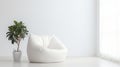 A white bean bag chair and a potted plant sit in a cozy room, creating a relaxing and inviting atmosphere