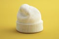 Of a white beanie on a yellow background, in a minimalist style, with high resolution Royalty Free Stock Photo