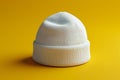 Of a white beanie on a yellow background, in a minimalist style, with high resolution Royalty Free Stock Photo