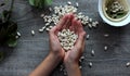 White beans and female hands symbolize healthy eating