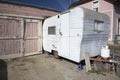 White beatup trailer parked in front of pink garage, Ventura, California, USA Royalty Free Stock Photo