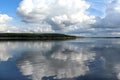 White clouds on blue sky with reflection in lake during the day in the natural environtent. Royalty Free Stock Photo