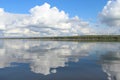 White clouds on blue sky with reflection in lake during the day in the natural environtent.