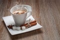 White beautiful cup on a rectangular saucer. Hot coffee with milk sprinkled with grated chocolate. Royalty Free Stock Photo
