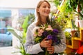 White beautiful florist girl holding bouquet with flowers in shop Royalty Free Stock Photo