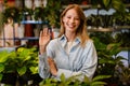 White beautiful florist girl smiling while working in flower shop Royalty Free Stock Photo