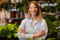 White beautiful florist girl smiling while working in flower shop Royalty Free Stock Photo