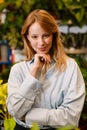 White beautiful florist girl smiling while working in flower shop Royalty Free Stock Photo