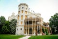 White beautiful state Chateau of Hluboka, neo-Gothic castle and gardens on a sunny summer day, famous national cultural landmark,