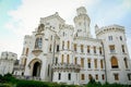 White beautiful state Chateau of Hluboka, neo-Gothic castle and gardens on a sunny summer day, famous national cultural landmark,