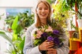 White beautiful florist girl holding bouquet with flowers in shop Royalty Free Stock Photo