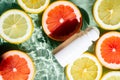 Beauty product roll on antiperspirant deodorant anti sweat smell on green waved water surface, lemon grapefruit slices