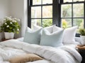 a white bed with white comforters and pillows Royalty Free Stock Photo