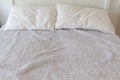 White bed and double pillow covered by messy wool. Royalty Free Stock Photo