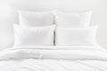 White bed , four white pillows and duvet on a bed Royalty Free Stock Photo