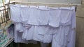 White bed linen hanging on clothespins, drying