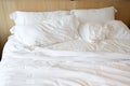 white bed and pillows and wood headboard in the room Royalty Free Stock Photo