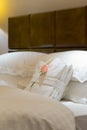 White bedgown with rose on bed