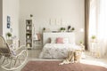 White bedroom interior with dirty pink carpet, rocking chair, wi Royalty Free Stock Photo