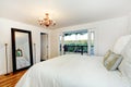 White bedroom interior with walkout deck