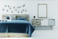 White bedroom with a poster, blue cover Royalty Free Stock Photo