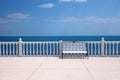 White bench, balustrade and empty terrace overlooking the sea Royalty Free Stock Photo