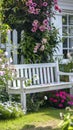 A white bench in front of a garden full of flowers, AI Royalty Free Stock Photo