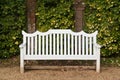 White bench in front of wall