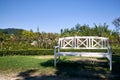 White bench at a garden during a sunny day,