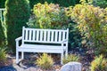 White Bench in a Garden Setting Royalty Free Stock Photo