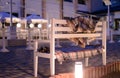 White Bench with Plaid Blankets on Patio at Dusk