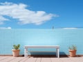 a white bench sitting in front of a blue brick wall Royalty Free Stock Photo