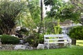 White bench in small garden for thai people sit and rest in morning time