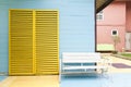 White bench and yellow door