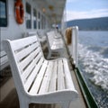 White benches on a ferry deck overlooking the sea. Royalty Free Stock Photo