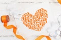 White berries, pumpkin, leaves and orange ribbon on a wooden mockup autumn background. Greeting card for Thanksgiving